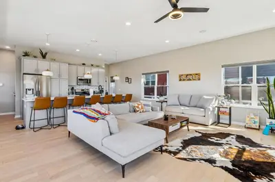 a living room with two couches and a kitchen at Family Fun Near Cedar Point - Rooftop Lake Views in Sandusky