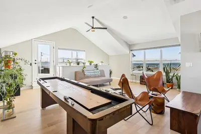 a living room with a pool table at Family Fun Near Cedar Point - Rooftop Lake Views in Sandusky
