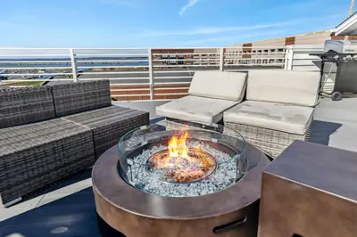 a balcony with a fire pit on a cruise ship at Family Fun Near Cedar Point - Rooftop Lake Views in Sandusky