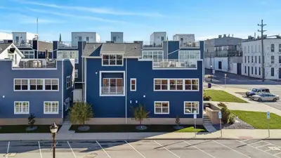 a blue building in a city with a parking lot at Family Fun Near Cedar Point - Rooftop Lake Views in Sandusky
