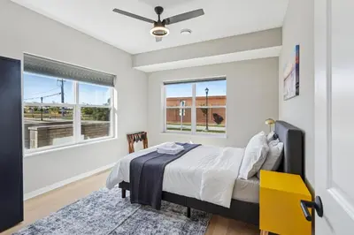 a bedroom with a bed and two windows at Family Fun Near Cedar Point - Rooftop Lake Views in Sandusky