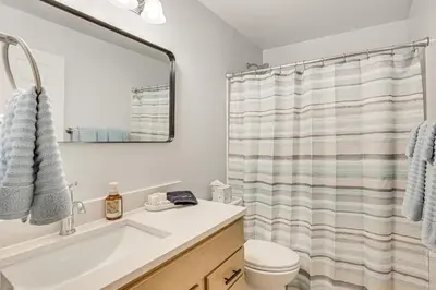 a bathroom with a sink and a shower curtain at Easy I-80 Access! Newly Updated McDonald Home
