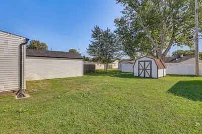 a yard with a small shed next to a house at Easy I-80 Access! Newly Updated McDonald Home