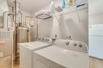 a kitchen with a washing machine and a refrigerator at Easy I-80 Access! Newly Updated McDonald Home
