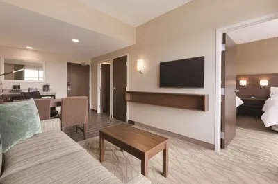 a living room with a couch and a tv at Embassy Suites by Hilton Akron Canton Airport in North Canton