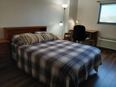 a bedroom with a bed and a desk and a chair at Right by OSU Stadium and Schottenstein Ctr - Walk to your game or concert in Columbus