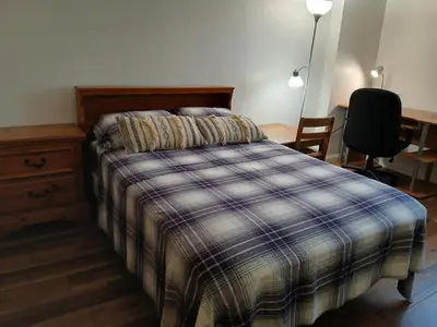 a bedroom with a bed and a desk and a chair at Right by OSU Stadium and Schottenstein Ctr - Walk to your game or concert in Columbus