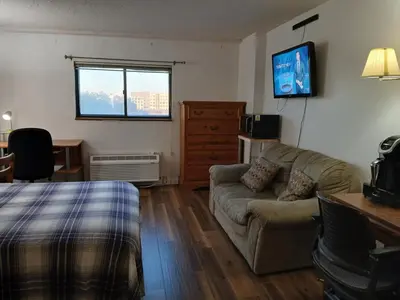 a living room with a couch and a tv at Right by OSU Stadium and Schottenstein Ctr - Walk to your game or concert in Columbus