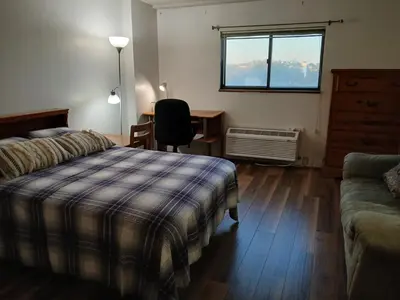 a bedroom with a bed and a desk and a window at Right by OSU Stadium and Schottenstein Ctr - Walk to your game or concert in Columbus