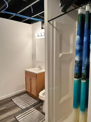 a bathroom with a toilet and a sink at Nice Basement room in the house in Medina