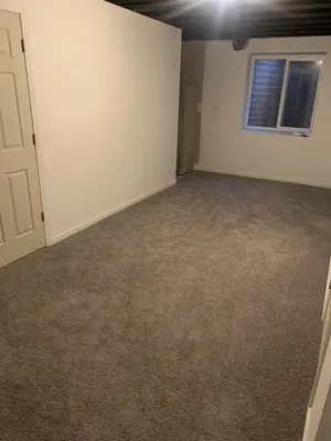 an empty room with a door and a window at Nice Basement room in the house in Medina
