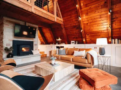 a living room with a couch and a fireplace at Cozy A-Frame Getaway Minutes from Nelson Ledges