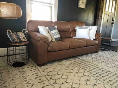 a brown couch sitting in a living room with pillows at Walnut Valley Farm guesthouse in Canton