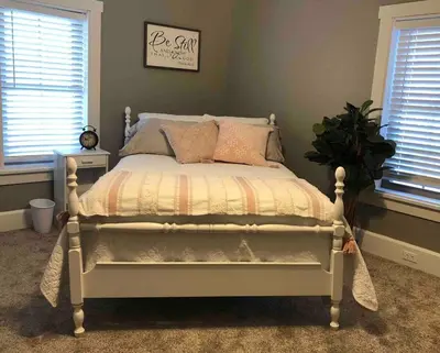 a bedroom with a white bed with a comforter at Walnut Valley Farm guesthouse in Canton