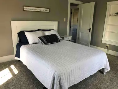 a bedroom with a large white bed with two pillows at Walnut Valley Farm guesthouse in Canton
