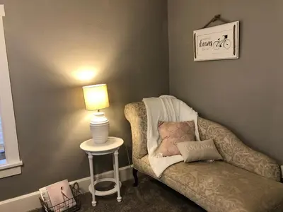 a room with a chair and a table with a lamp at Walnut Valley Farm guesthouse in Canton