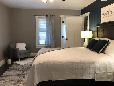 a bedroom with a bed and a chair and a window at Walnut Valley Farm guesthouse in Canton
