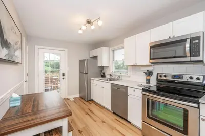 a kitchen with white cabinets and stainless steel appliances at Valley Ridge Retreat - For 8 in Cincinnati
