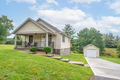 a small house with a porch and a lawn at Valley Ridge Retreat - For 8 in Cincinnati