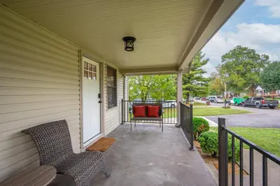 a porch with two chairs on a house at Valley Ridge Retreat - For 8 in Cincinnati