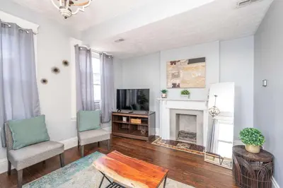 a living room with a fireplace and a tv at Queen City Suites 2 - For 4 in Cincinnati