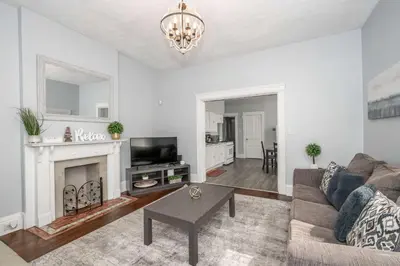 a living room with a couch and a fireplace at Queen City Suites - For 7 in Cincinnati