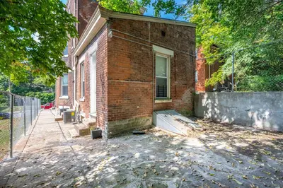 a brick house with a window on the side of it at Queen City Suites - For 7 in Cincinnati