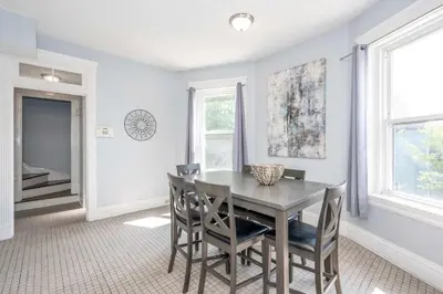 a dining room with a table and chairs at Queen City Suites - For 7 in Cincinnati