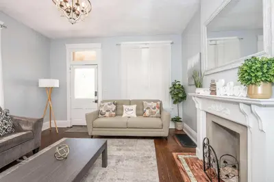 a living room with a couch and a fireplace at Queen City Suites 1 - For 3 in Cincinnati