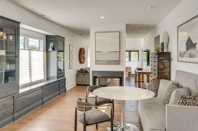 a living room with a table and chairs at 7 Mi to Dtwn and Lake Erie Sleek Cleveland Apt! in Cleveland