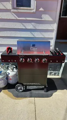 a barbecue grill sitting outside of a house at The Funky Fun Haus - Pickleball, Hot Tub, Arcade in Columbus