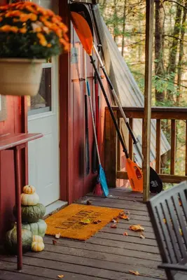 a porch of a house with an open door at Waterfront A Frame with Dock Canoe Kayaks Family in Rockbridge