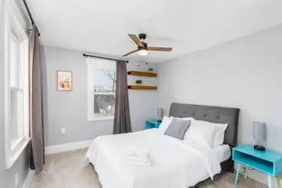 a white bedroom with a bed and a window at Modern 3BR w Yard Garage in Columbus