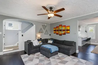 a living room with a couch and a ceiling fan at Modern 3BR w Yard Garage in Columbus