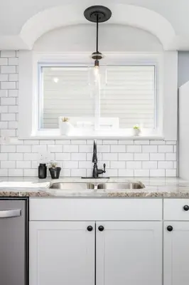 a white kitchen with a sink and a window at Modern 3BR w Yard Garage in Columbus