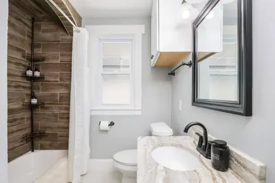 a bathroom with a sink and a tub and a toilet at Modern 3BR w Yard Garage in Columbus