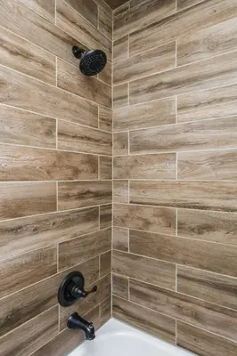 a bathroom with a shower with wooden tiles at Modern 3BR w Yard Garage in Columbus