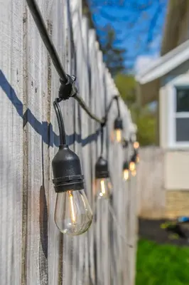 a group of lights hanging on a fence at Modern 3BR w Yard Garage in Columbus