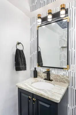 a bathroom with a sink and a mirror at Modern 3BR w Yard Garage in Columbus