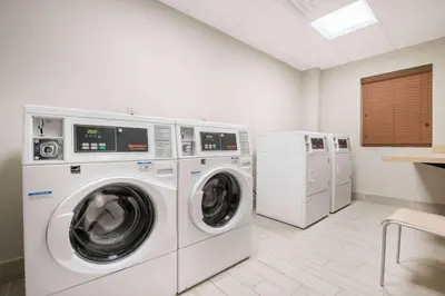 a laundry room with a washer and dryer at Hawthorn Suites by Wyndham Bridgeport in Bridgeport