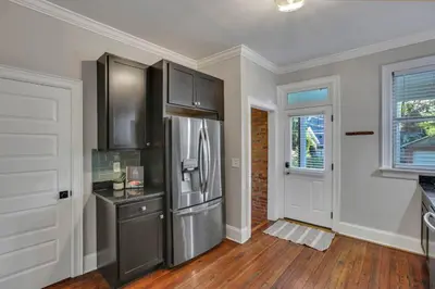 a kitchen with a stainless steel refrigerator at Charming Historic Getaway in the Heart of Columbus in Columbus