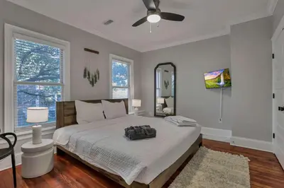 a bedroom with a bed with a backpack on it at Charming Historic Getaway in the Heart of Columbus in Columbus