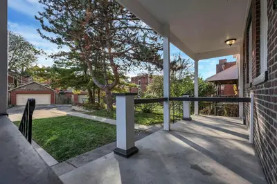 an empty porch of a house with a fence at Charming Historic Getaway in the Heart of Columbus in Columbus