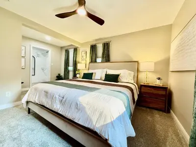 a bedroom with a large bed with a ceiling fan at Brand new remodeled home in Monroe in Monroe