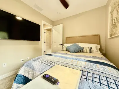 a bedroom with a bed with a tv on the wall at Brand new remodeled home in Monroe in Monroe