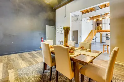 a dining room with a table and chairs at Walk to Huntington Center 5,000-Sq-Ft Dtwn Apt in Toledo