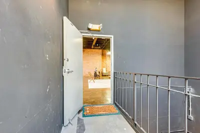 a hallway with a door leading into a room at Walk to Huntington Center 5,000-Sq-Ft Dtwn Apt in Toledo