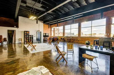 a large room with chairs and tables and windows at Walk to Huntington Center 5,000-Sq-Ft Dtwn Apt in Toledo