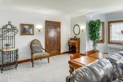 a living room with a couch and a table at Striking Tudor Revival in Five Points District! in Toledo