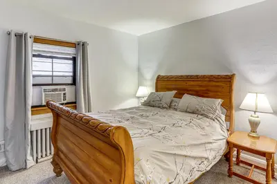 a bedroom with a large bed and a window at Striking Tudor Revival in Five Points District! in Toledo